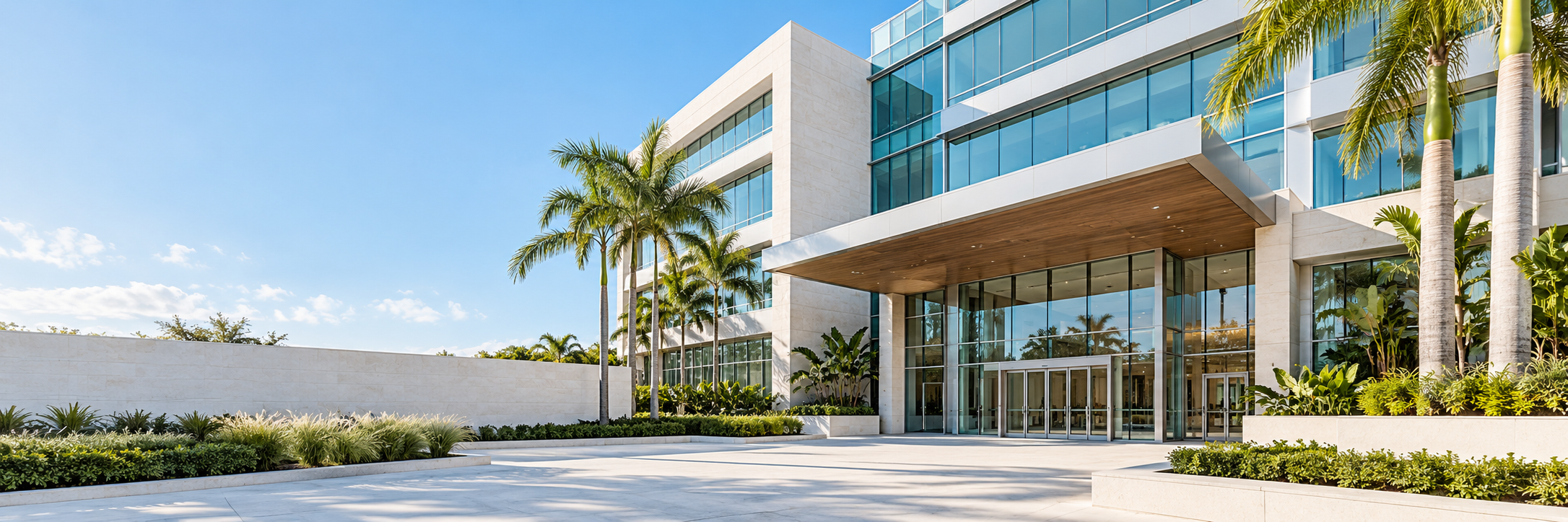 Illustrative modern Miami office building with a glass entrance, palm trees and landscaped grounds.